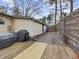 Corner of back deck with grill, gravel, yard, and entrance to the house at 883 Verona Dr, Clarkston, GA 30021