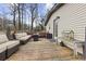 Wide shot of back deck with built-in seating, outdoor table, and greenery at 883 Verona Dr, Clarkston, GA 30021