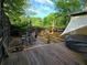 Wood backyard deck with outdoor seating, string lights, and privacy fence at 883 Verona Dr, Clarkston, GA 30021