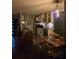 View of kitchen with stainless steel appliances, white cabinets, and a wooden dining table with chairs at 883 Verona Dr, Clarkston, GA 30021