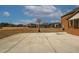 Spacious backyard with concrete basketball court and neighborhood view at 1504 Everson Walk, Hampton, GA 30228