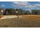 Large backyard with concrete patio and basketball court at 1504 Everson Walk, Hampton, GA 30228