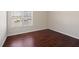 Spacious bedroom with wood floors and large window at 1504 Everson Walk, Hampton, GA 30228