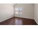 Bright bedroom featuring wood floors and a window with blinds at 1504 Everson Walk, Hampton, GA 30228