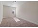 Simple bedroom with neutral walls and carpeted floor. Includes a window for natural light at 1504 Everson Walk, Hampton, GA 30228