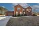 Brick home with a three-car garage and large driveway at 1504 Everson Walk, Hampton, GA 30228