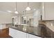 Modern kitchen featuring granite countertops and ample cabinet space at 1504 Everson Walk, Hampton, GA 30228