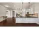 Open kitchen with large island and granite countertops at 1504 Everson Walk, Hampton, GA 30228