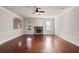 Spacious living room featuring hardwood floors, a fireplace, and ceiling fan at 1504 Everson Walk, Hampton, GA 30228