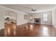 Large living room with hardwood floors, fireplace, and kitchen view at 1504 Everson Walk, Hampton, GA 30228