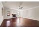 Spacious living room with hardwood floors, fireplace and a ceiling fan at 1504 Everson Walk, Hampton, GA 30228