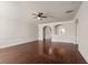 Spacious living area with hardwood floors, high ceilings, and arched entryways at 1504 Everson Walk, Hampton, GA 30228