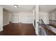 Upstairs hallway with hardwood floors and multiple doors at 1504 Everson Walk, Hampton, GA 30228