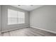 Bright bedroom with large window, grey walls, and wood-look flooring at 2793 Keystone Ave, Lithonia, GA 30058