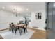 Bright dining room with farmhouse table, chandelier, and hardwood floors at 3839 Redbud Se Ct, Smyrna, GA 30082