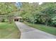 Ranch home with a long driveway and mature trees at 3839 Redbud Se Ct, Smyrna, GA 30082