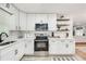 White kitchen with stainless steel appliances and subway tile backsplash at 3839 Redbud Se Ct, Smyrna, GA 30082