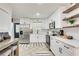 Modern white kitchen with stainless steel appliances and white cabinets at 3839 Redbud Se Ct, Smyrna, GA 30082