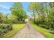 Long driveway leading to a charming yellow house nestled among lush greenery at 4050 Old Fairburn Rd, Atlanta, GA 30349