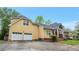 Two-car garage and inviting front porch of this charming home at 4050 Old Fairburn Rd, Atlanta, GA 30349