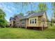 Side view of a charming yellow house with a large backyard at 4050 Old Fairburn Rd, Atlanta, GA 30349