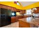 Kitchen boasts dark wood cabinets, granite island and yellow walls at 4050 Old Fairburn Rd, Atlanta, GA 30349