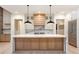 Modern kitchen with marble island, wooden cabinets, and black pendant lights at 427 Jon Scott Dr, Alpharetta, GA 30009