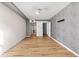 Light-filled bedroom with hardwood floors and grey accent wall at 620 Peachtree Ne St # 1412, Atlanta, GA 30308