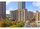 An exterior view of a high-rise apartment building with multiple balconies and surrounding greenery at 620 Peachtree Ne St # 1412, Atlanta, GA 30308