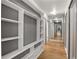 Bright hallway with built-in shelving and hardwood floors at 620 Peachtree Ne St # 1412, Atlanta, GA 30308