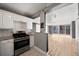 View of the kitchen from the living room, highlighting the stainless steel stove and granite countertops at 620 Peachtree Ne St # 1412, Atlanta, GA 30308