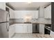 Well-equipped kitchen featuring white cabinets and granite countertops at 620 Peachtree Ne St # 1412, Atlanta, GA 30308