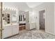 Double vanity bathroom with a large mirror and view to bedroom at 1085 Grace Hadaway Ln, Lawrenceville, GA 30043