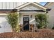 Front entrance with a black door, stone accents, and a rocking chair at 2603 Apple Valley Ne Rd, Brookhaven, GA 30319