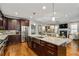 Open kitchen with large island, stainless steel appliances, and hardwood floors at 2603 Apple Valley Ne Rd, Brookhaven, GA 30319
