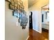 Inviting hallway showcasing a unique photo display and grandfather clock at 308 Hillpine Dr, Woodstock, GA 30189