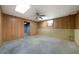 Unfinished basement with concrete floor and wood paneling at 12 Spruce Ne St, White, GA 30184