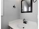 Small bathroom with single sink and framed mirror at 12 Spruce Ne St, White, GA 30184