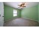 Light green bedroom with carpet, ceiling fan, and double doors at 12 Spruce Ne St, White, GA 30184