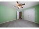 Bedroom with ceiling fan and double closet doors at 12 Spruce Ne St, White, GA 30184