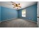 Blue bedroom with ceiling fan and window with blinds at 12 Spruce Ne St, White, GA 30184