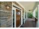 Inviting front door with stone accents and a wood door at 12 Spruce Ne St, White, GA 30184