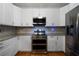 Modern kitchen with stainless steel appliances and granite countertops at 12 Spruce Ne St, White, GA 30184