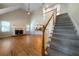 Two-story living room with hardwood floors, fireplace, and high ceilings at 12 Spruce Ne St, White, GA 30184