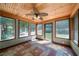 Sunroom with tiled floor, ceiling fan, and many windows at 12 Spruce Ne St, White, GA 30184