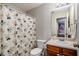 Bathroom with Mickey Mouse shower curtain and wooden vanity at 228 Ridge Mill Dr, Acworth, GA 30102