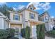 Tan and beige townhome with a white garage door and landscaping at 228 Ridge Mill Dr, Acworth, GA 30102