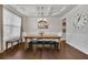 Formal dining room with hardwood floors, chandelier, and large clock at 5330 Austrian Pine Ct, Cumming, GA 30040