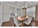 Bright dining room with hardwood floors, chandelier, and coffered ceiling at 5330 Austrian Pine Ct, Cumming, GA 30040