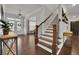 Bright entryway with hardwood floors, staircase, and console table at 5330 Austrian Pine Ct, Cumming, GA 30040